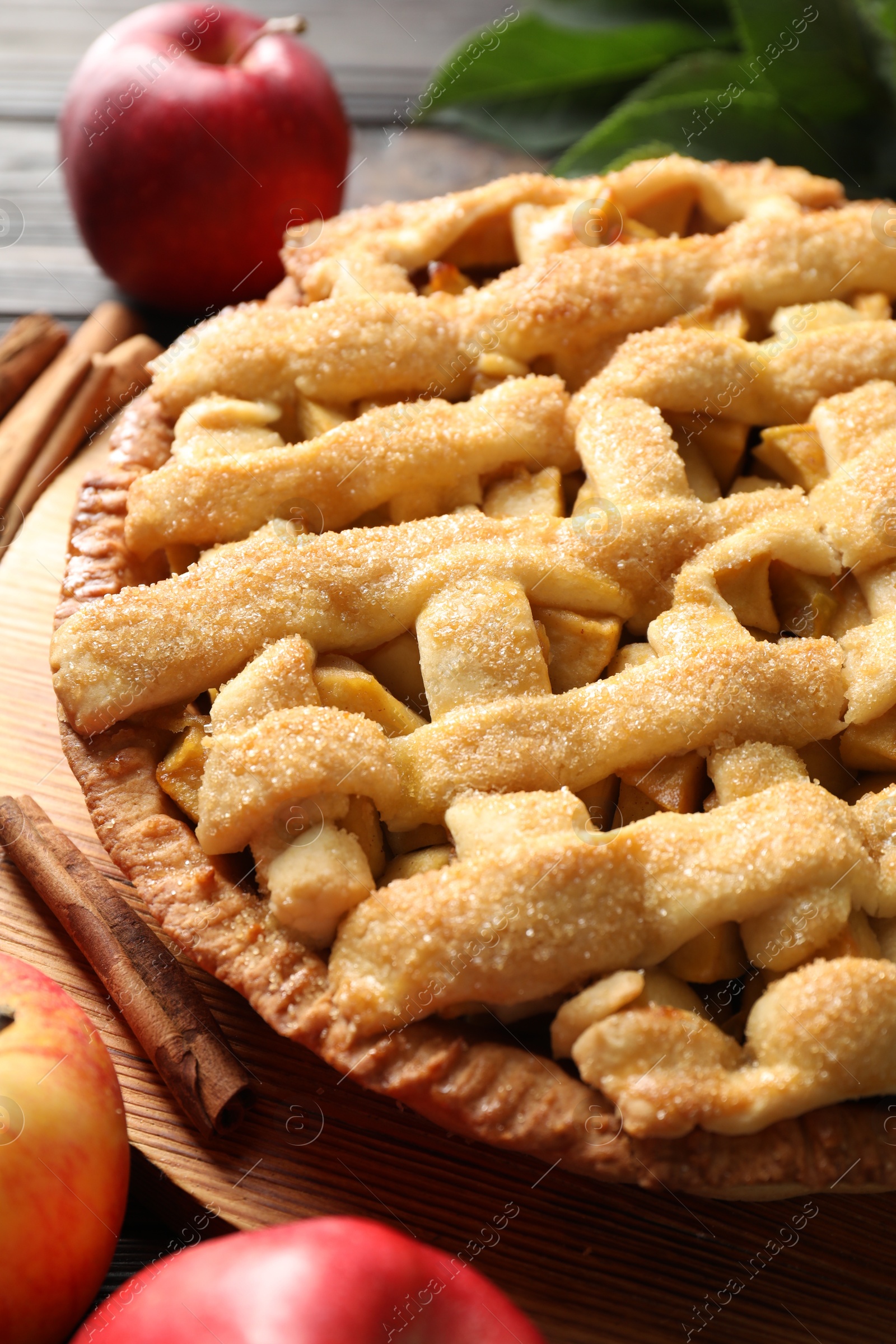 Photo of Tasty homemade apple pie and ingredients on table, closeup