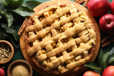 Tasty homemade apple pie and ingredients on table, flat lay