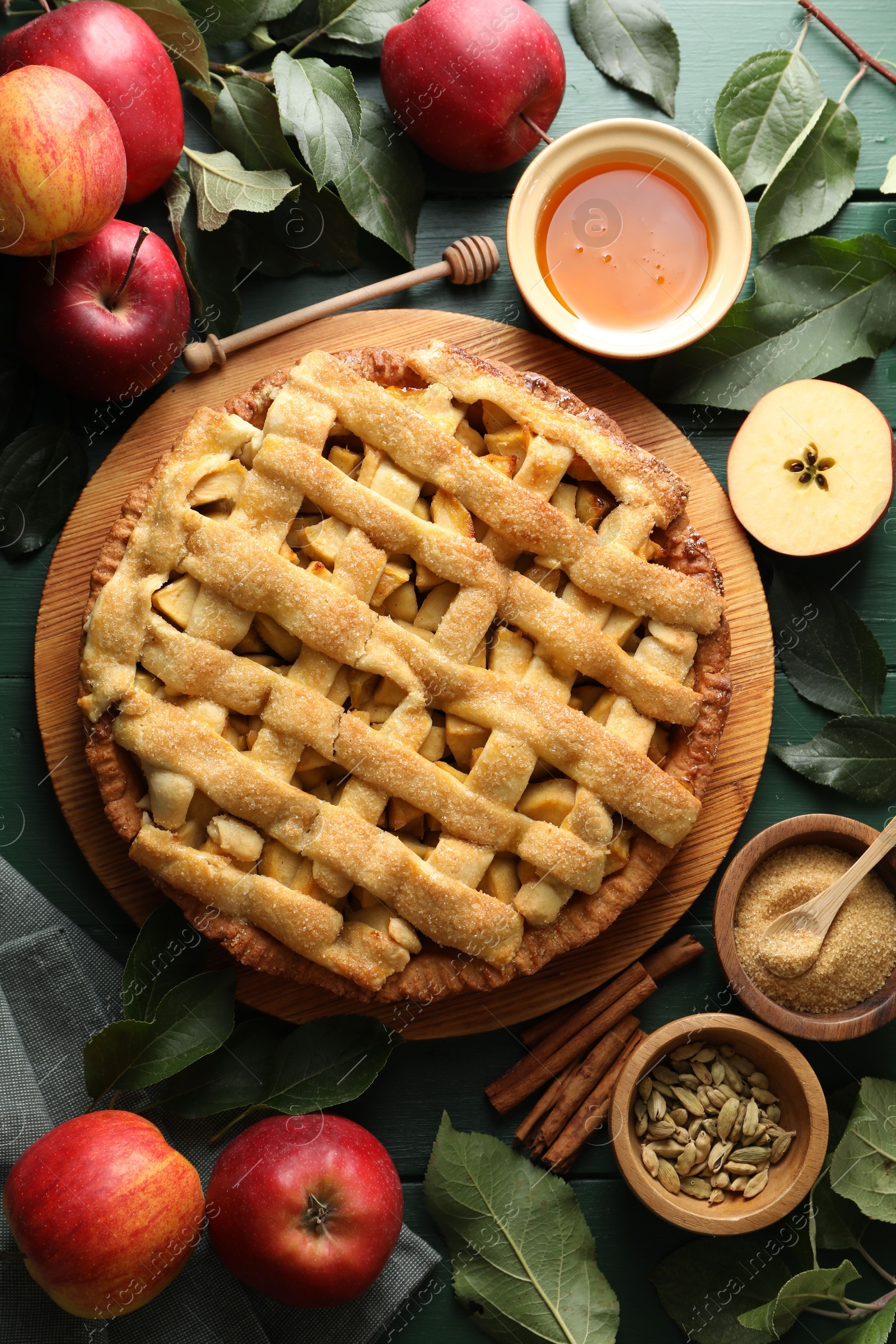 Photo of Tasty homemade apple pie and ingredients on table, flat lay