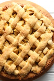 Tasty homemade apple pie on white wooden table, top view