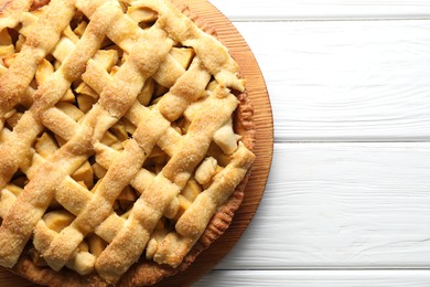 Tasty homemade apple pie on white wooden table, top view. Space for text