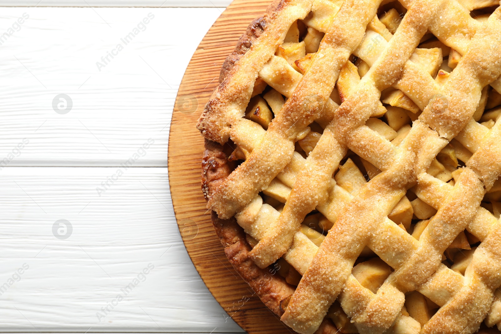 Photo of Tasty homemade apple pie on white wooden table, top view. Space for text