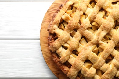 Photo of Tasty homemade apple pie on white wooden table, top view. Space for text