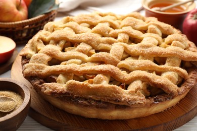 Photo of Tasty homemade apple pie and ingredients on table, closeup