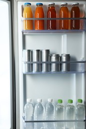 Many different cold drinks in refrigerator, closeup