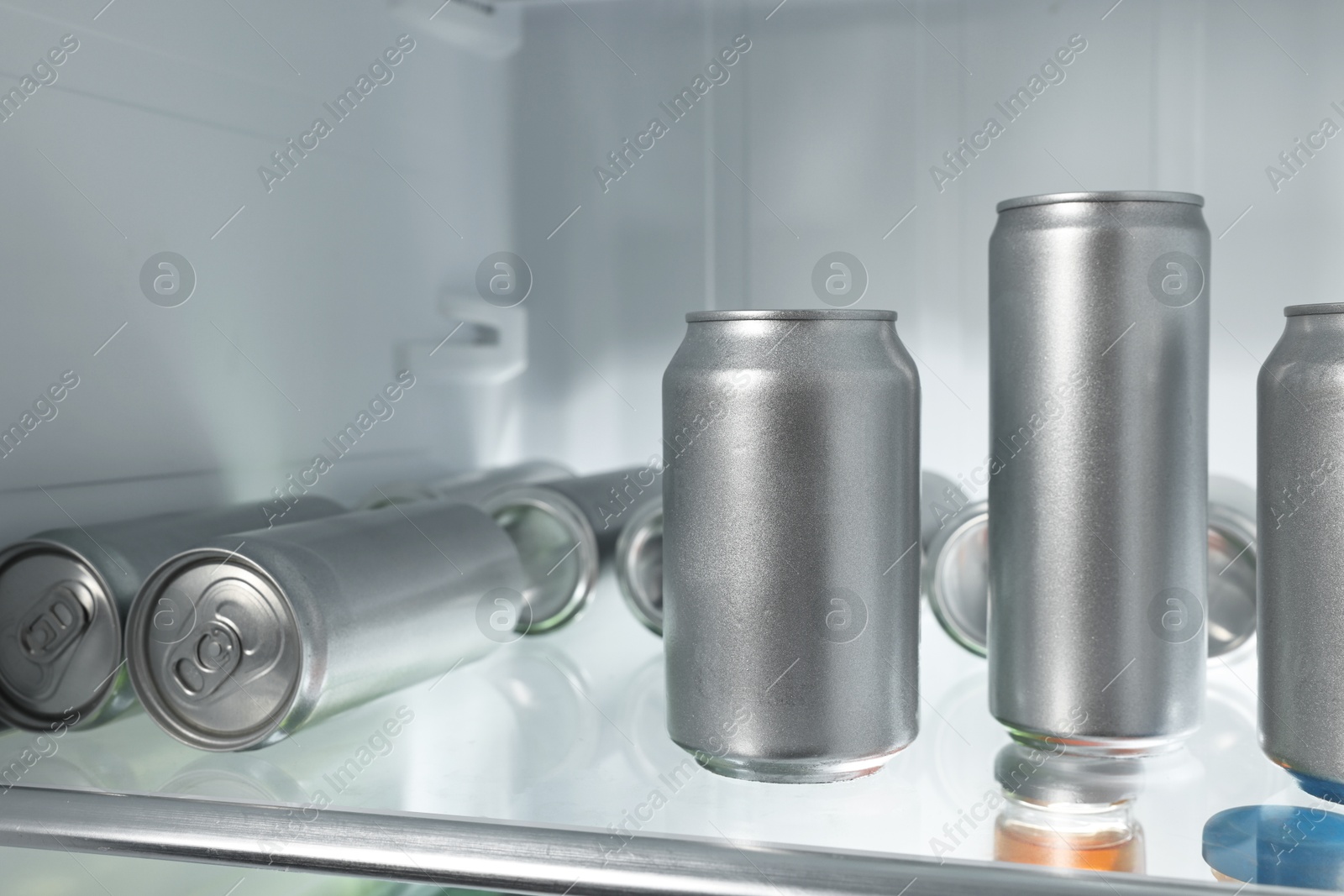 Photo of Many cans of beer in refrigerator, closeup