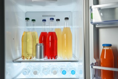 Photo of Many different cold drinks in refrigerator, closeup