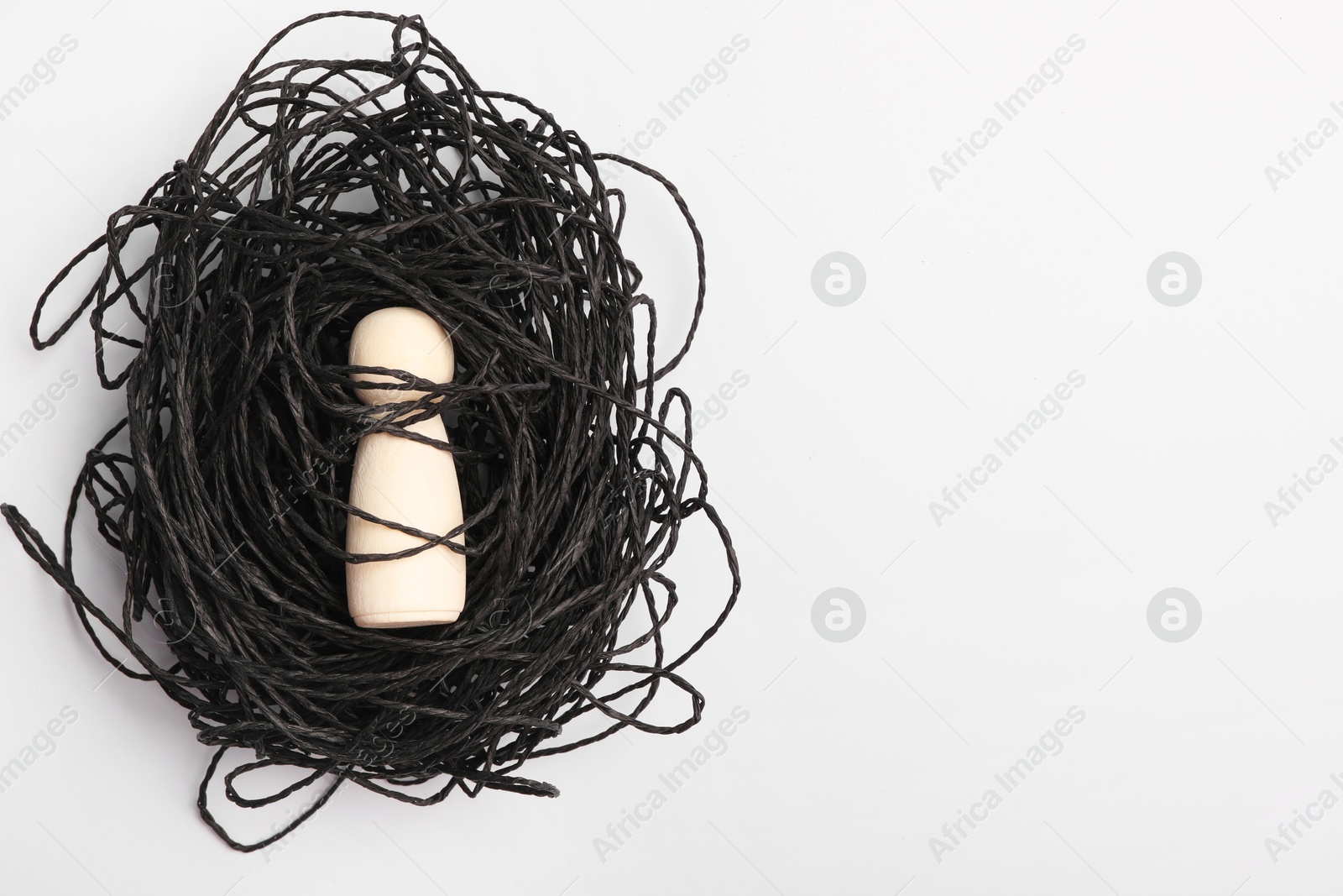 Photo of Loneliness concept. Human figure caught in net of thoughts on white background, top view. space for text