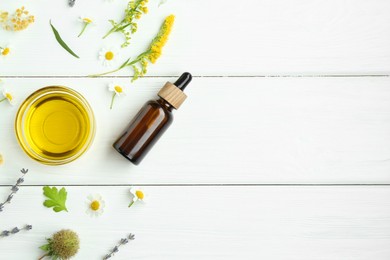 Photo of Tinctures and medicinal herbs on white wooden table, flat lay. Space for text