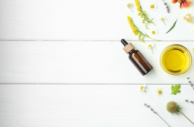 Photo of Tinctures and medicinal herbs on white wooden table, flat lay. Space for text