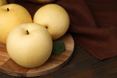 Delicious fresh apple pears on wooden table, closeup