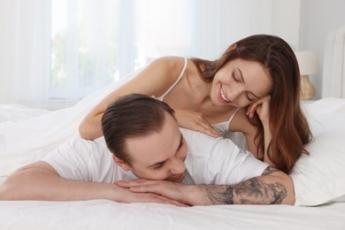 Happy couple spending time together on bed at home