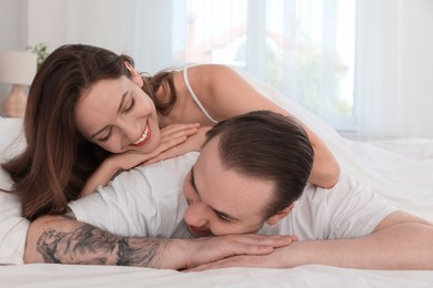 Happy couple spending time together on bed at home