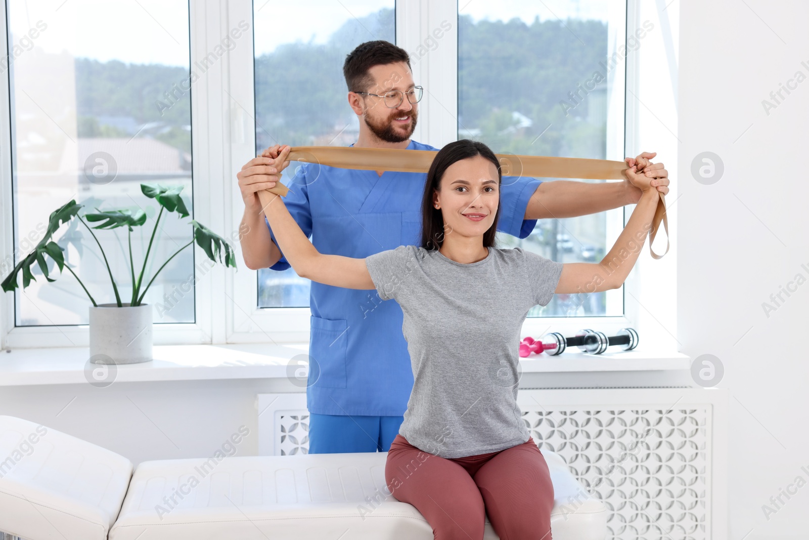 Photo of Physiotherapist working with patient in rehabilitation center