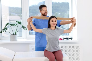 Physiotherapist working with patient in rehabilitation center