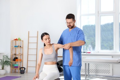 Physiotherapist working with patient in rehabilitation center