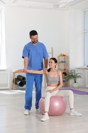 Physiotherapist working with patient in rehabilitation center