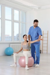 Physiotherapist working with patient in rehabilitation center