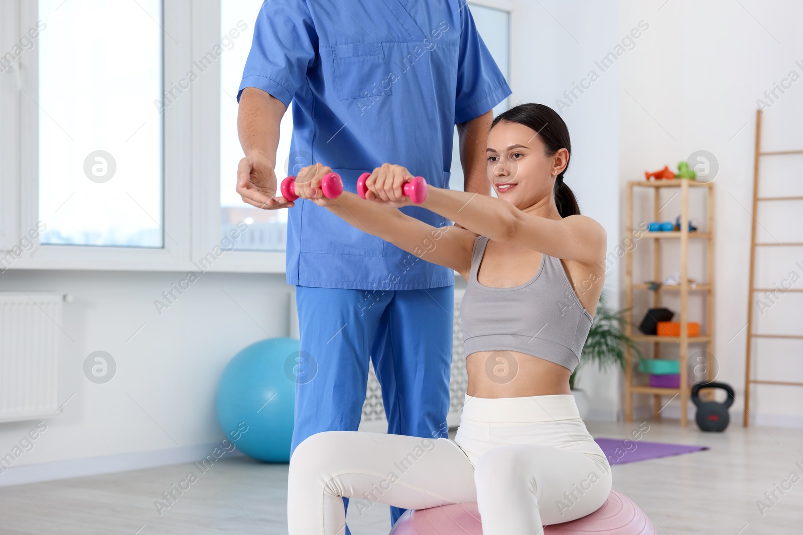 Photo of Patient exercising under physiotherapist supervision in rehabilitation center