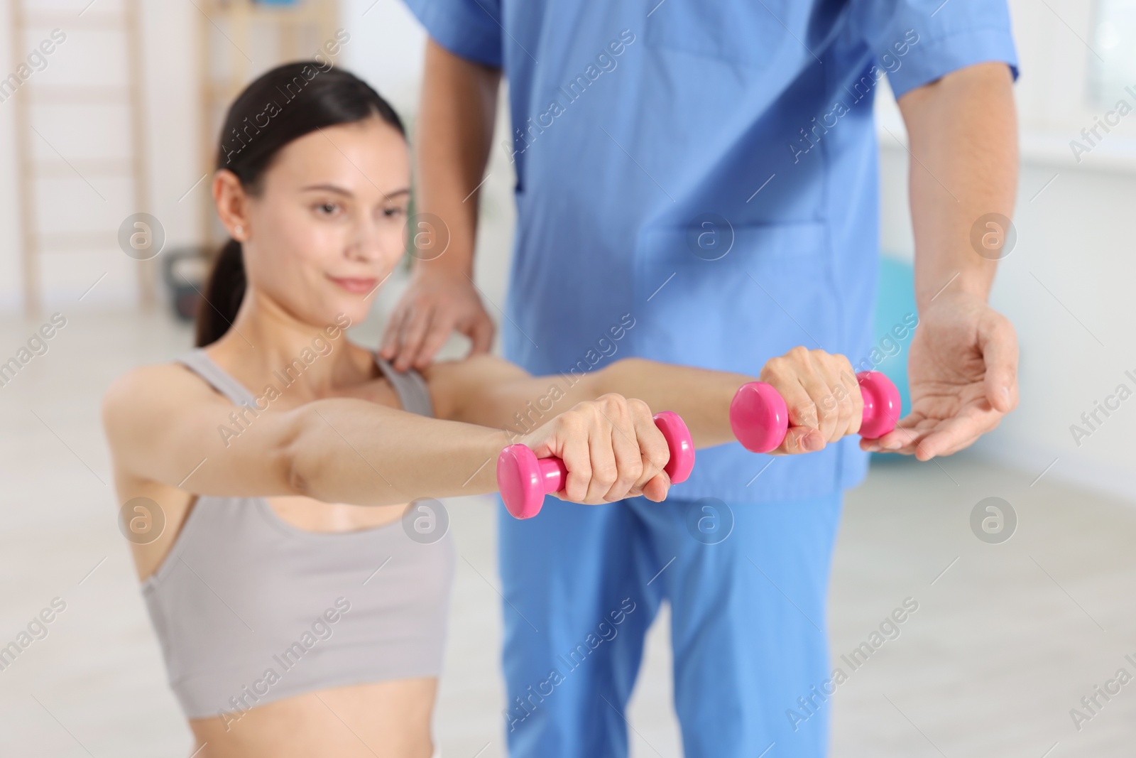 Photo of Patient exercising under physiotherapist supervision in rehabilitation center