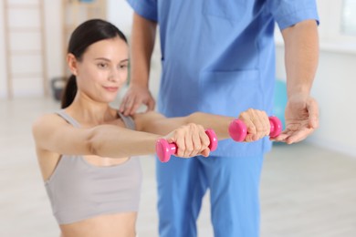 Photo of Patient exercising under physiotherapist supervision in rehabilitation center