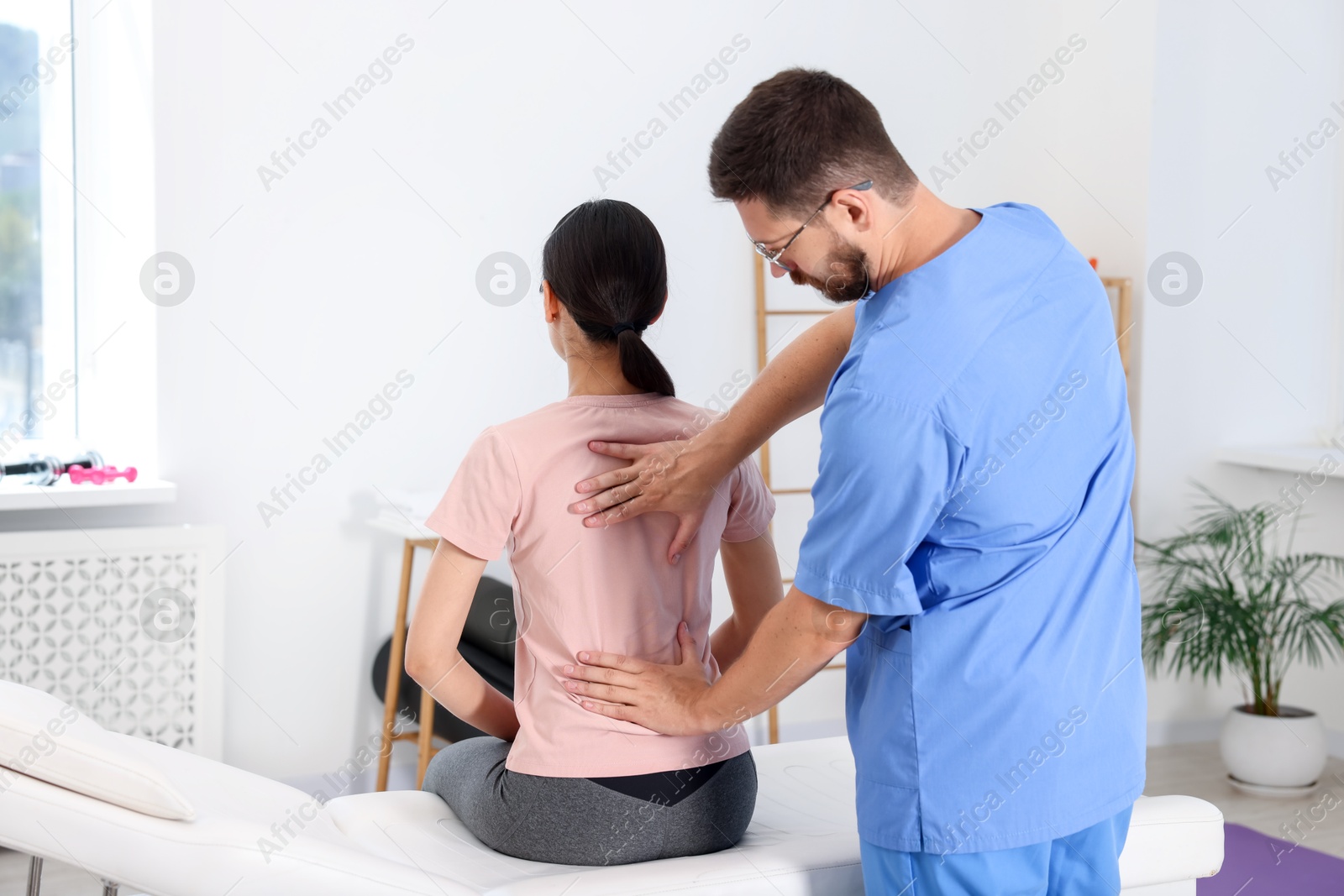 Photo of Physiotherapist working with patient in rehabilitation center