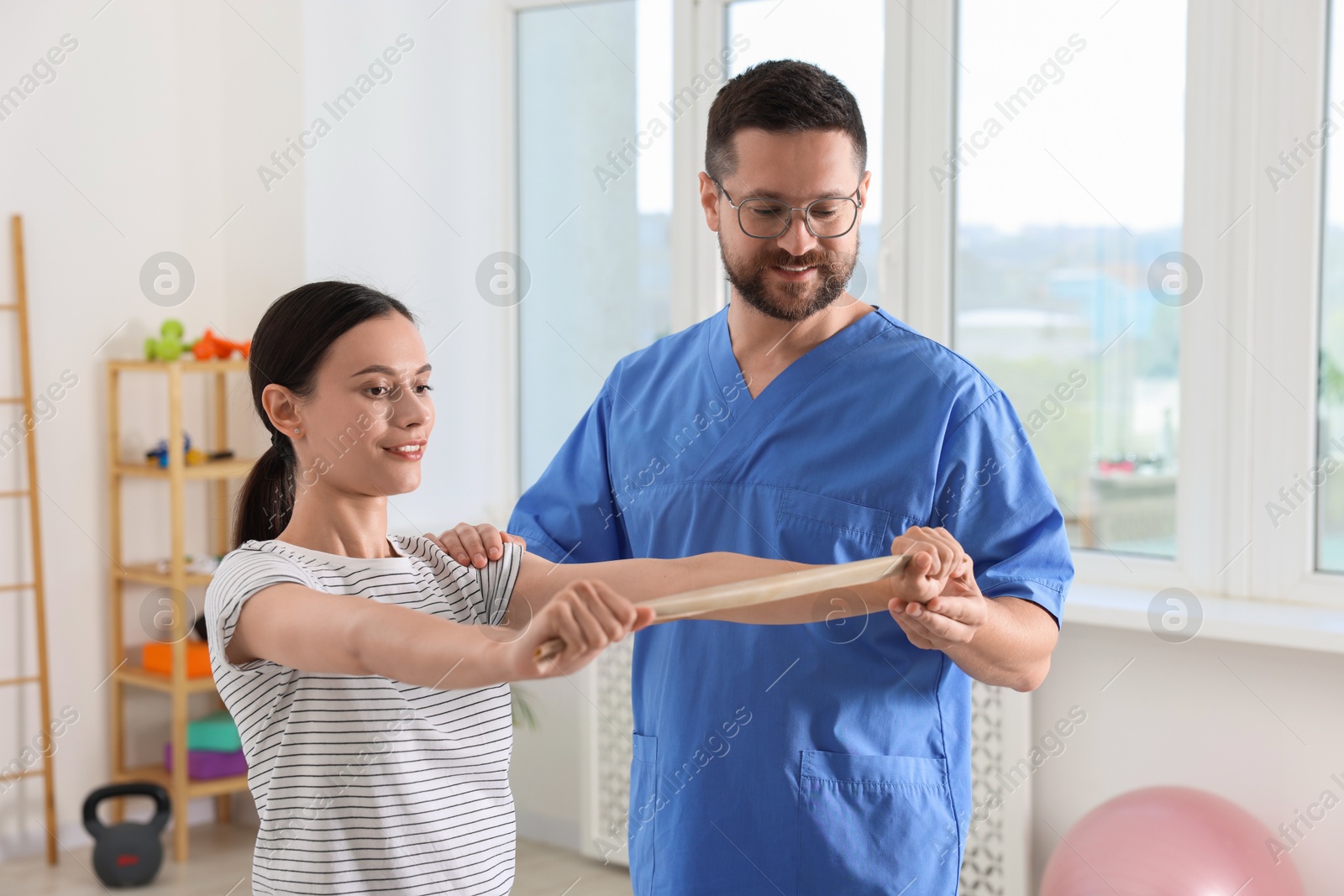 Photo of Patient exercising under physiotherapist supervision in rehabilitation center