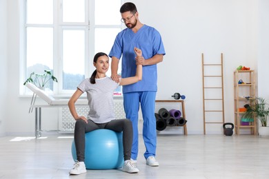 Physiotherapist working with patient in rehabilitation center