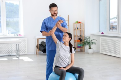 Physiotherapist working with patient in rehabilitation center