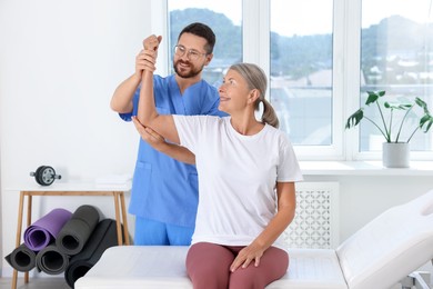 Physiotherapist working with senior patient in rehabilitation center