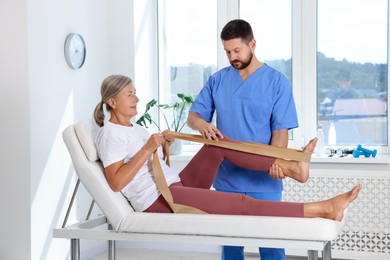 Physiotherapist working with senior patient in rehabilitation center