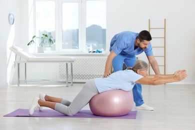 Physiotherapist working with senior patient in rehabilitation center