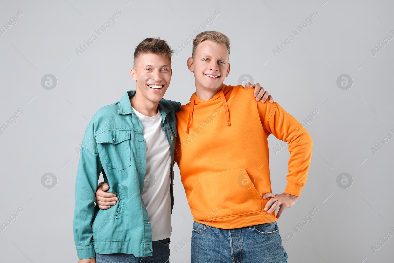 Photo of Portrait of two happy brothers on light background