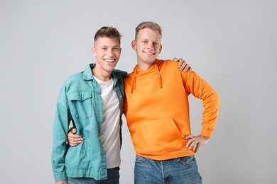 Portrait of two happy brothers on light background