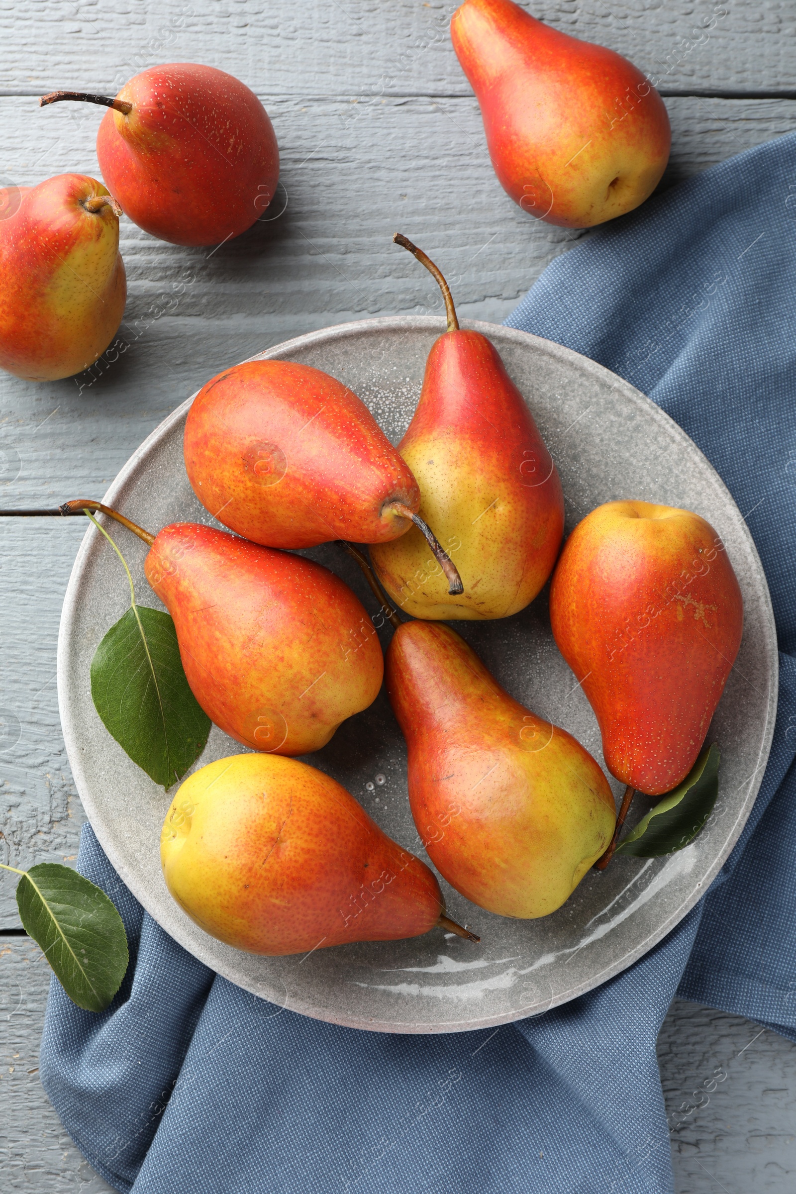 Photo of Ripe juicy pears on grey wooden table, flat lay