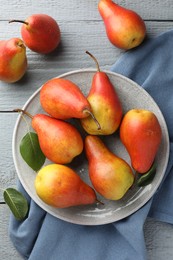 Photo of Ripe juicy pears on grey wooden table, flat lay