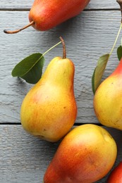 Photo of Ripe juicy pears on grey wooden table, flat lay