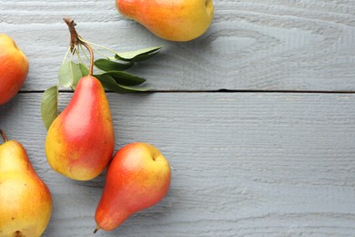 Photo of Ripe juicy pears on grey wooden table, flat lay. Space for text