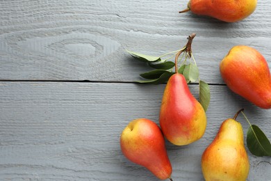 Photo of Ripe juicy pears on grey wooden table, flat lay. Space for text