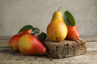 Photo of Many ripe juicy pears on wooden table