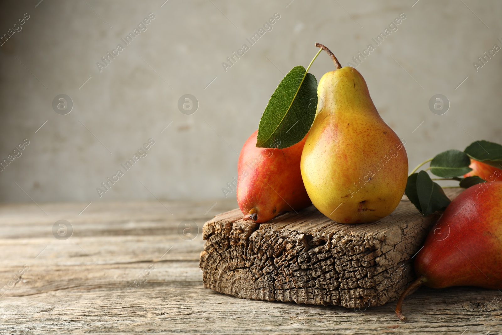 Photo of Ripe juicy pears on wooden table, space for text