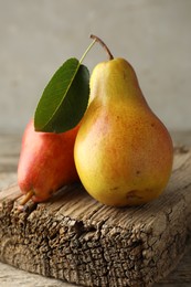 Photo of Two ripe juicy pears on wooden table