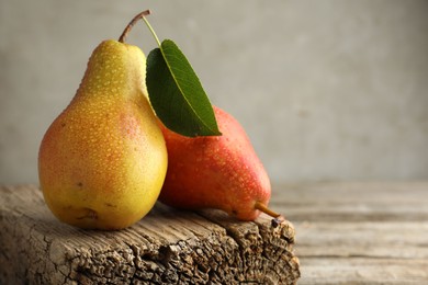 Photo of Ripe juicy pears drops on wooden table, closeup. Space for text