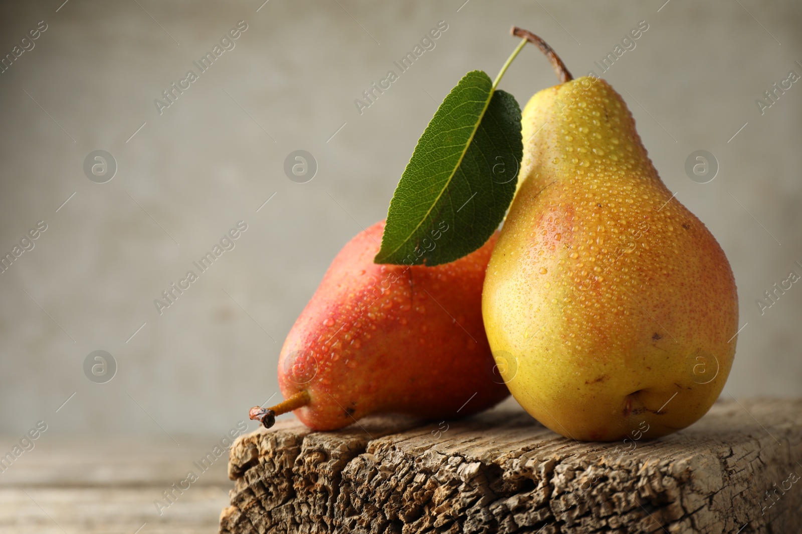 Photo of Ripe juicy pears drops on wooden table, closeup. Space for text