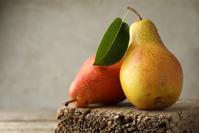 Photo of Ripe juicy pears drops on wooden table, closeup. Space for text