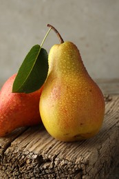 Photo of Ripe juicy pears on table against grey background, closeup