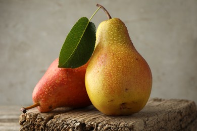 Photo of Ripe juicy pears on table against grey background, closeup