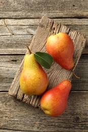 Photo of Ripe juicy pears on wooden table, top view