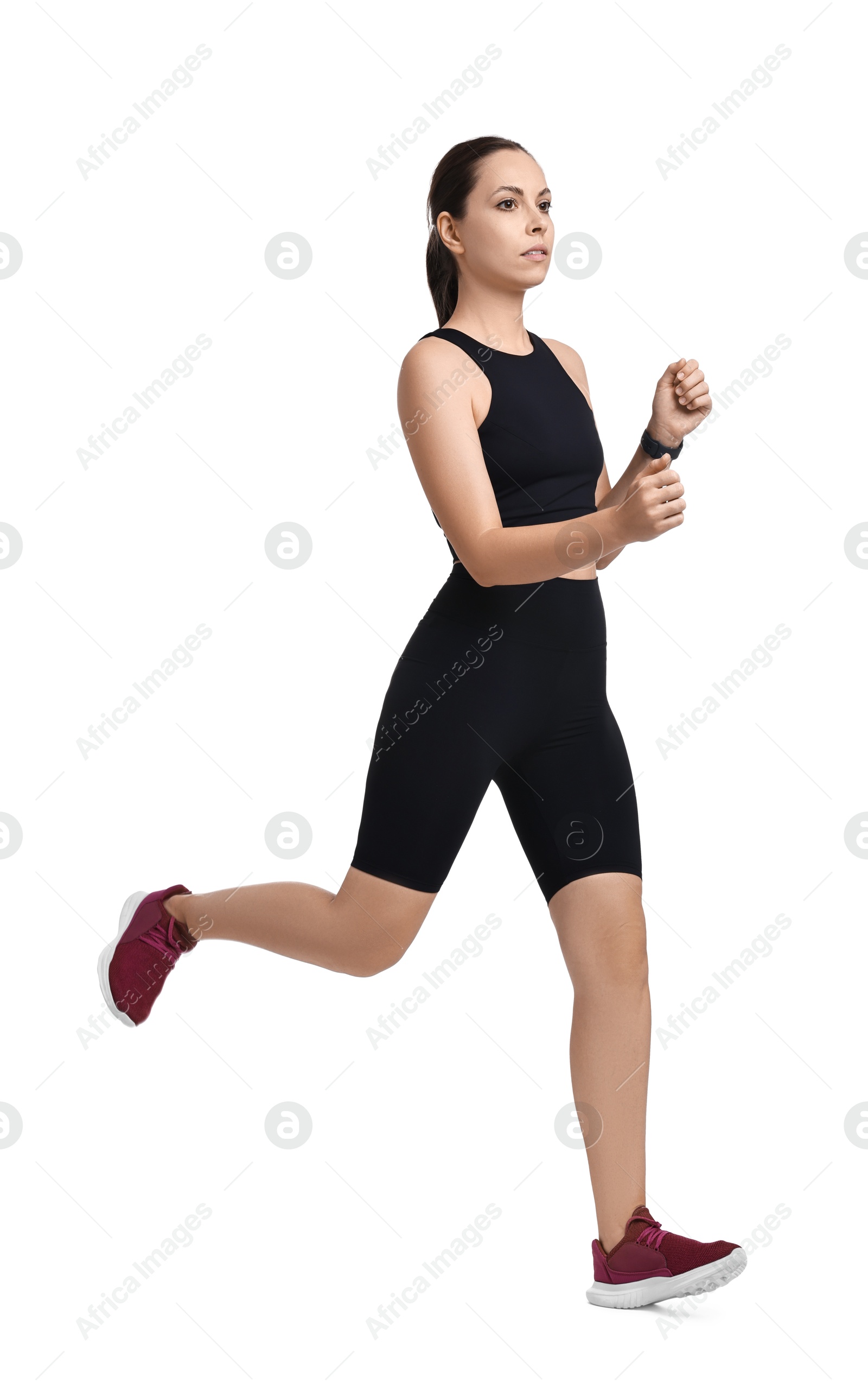 Photo of Athletic woman in sportswear running on white background