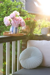 Photo of Balcony garden. Different plants on railings outdoors on sunny day